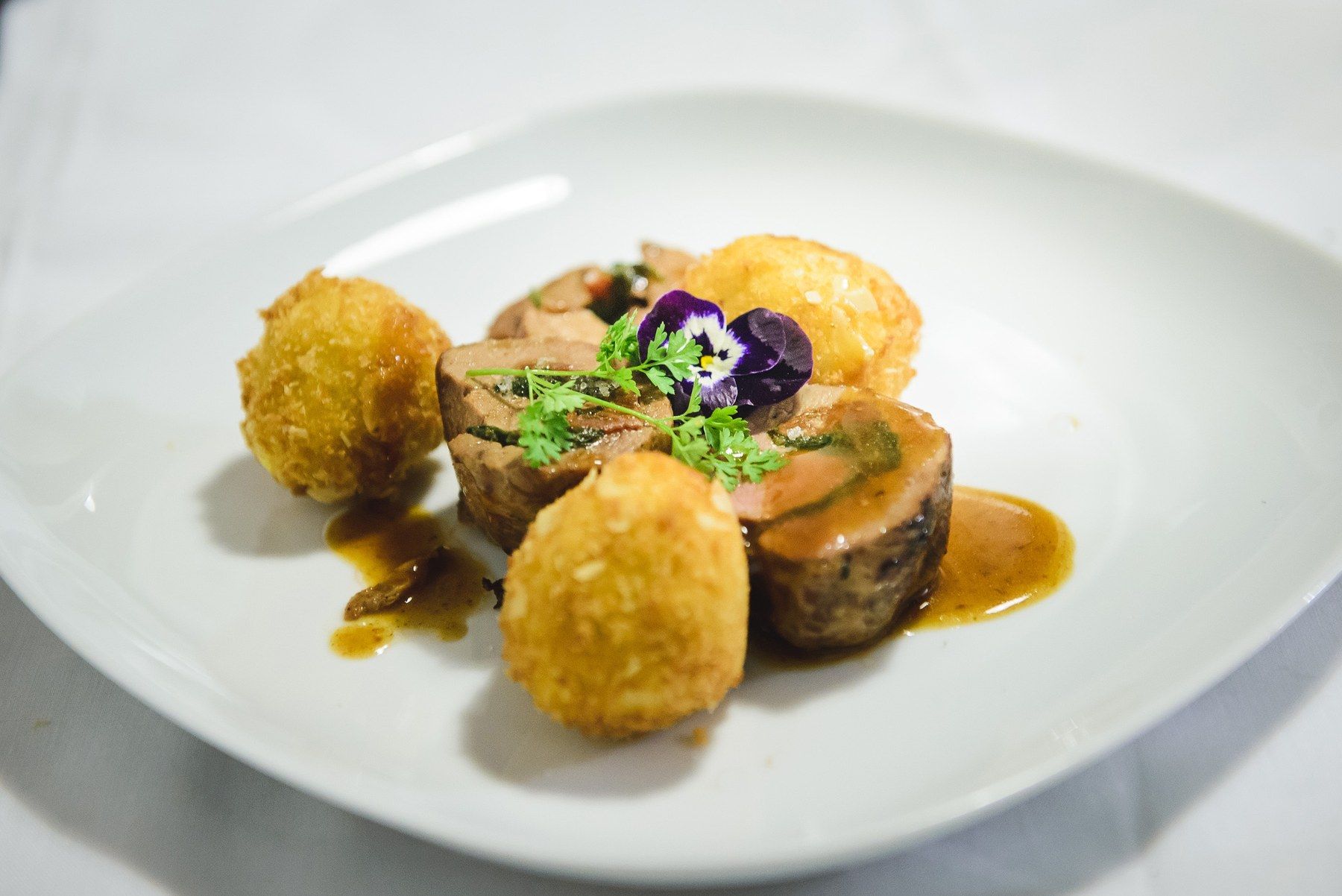 Golden potato croquettes with a rich jus.