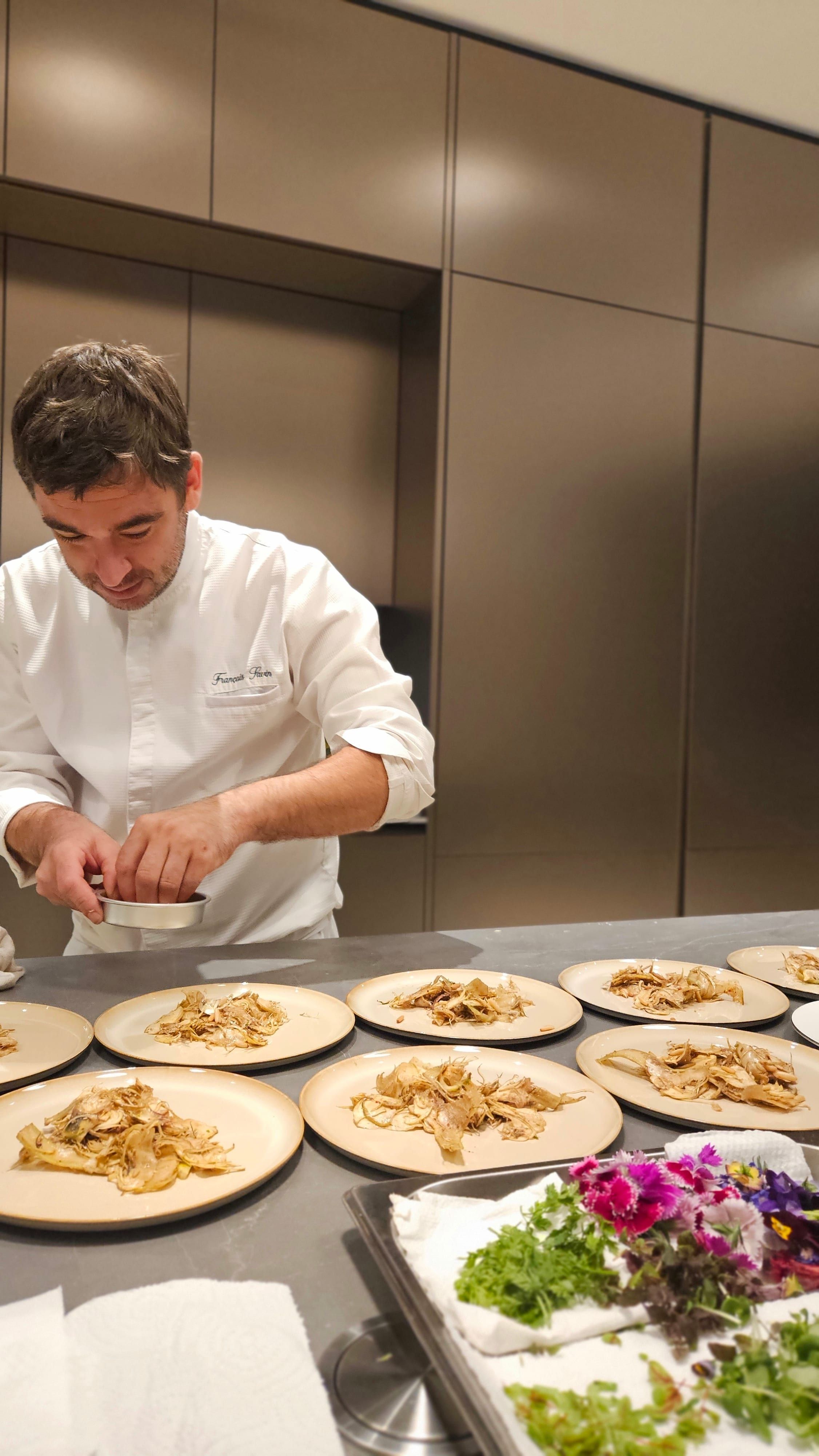Chef François Savin plating a course at the venue.