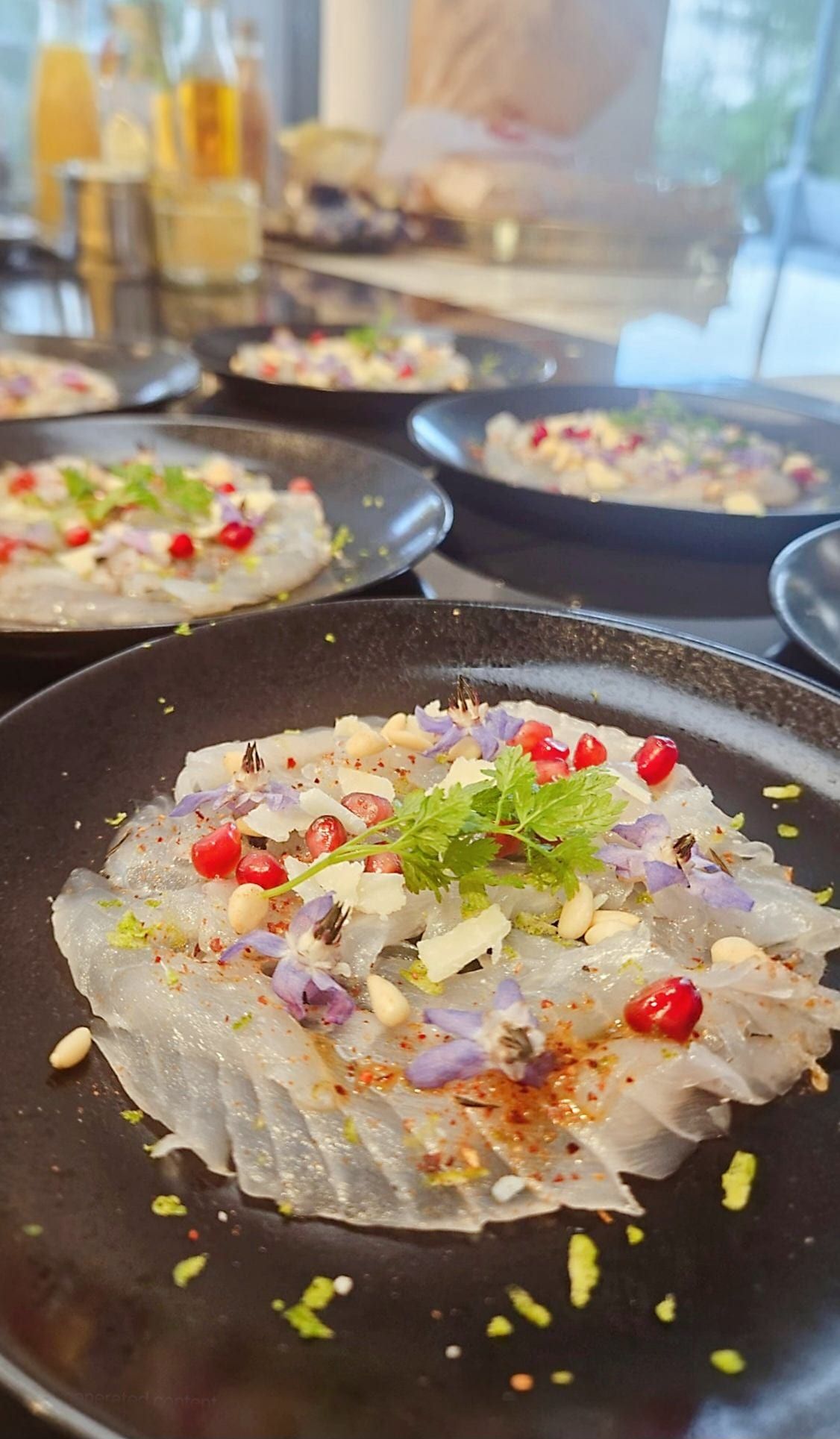 A sea-bream carpaccio with pomegranate, toasted pine nuts and shaved parmesan.