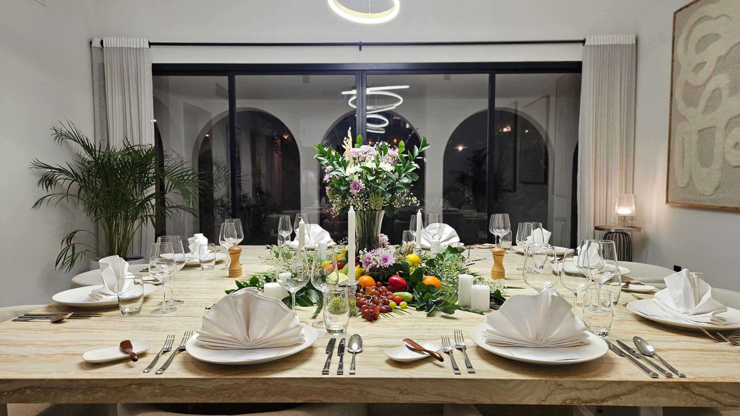 A Dubai dining table dressed with flowers and glassware for the evening