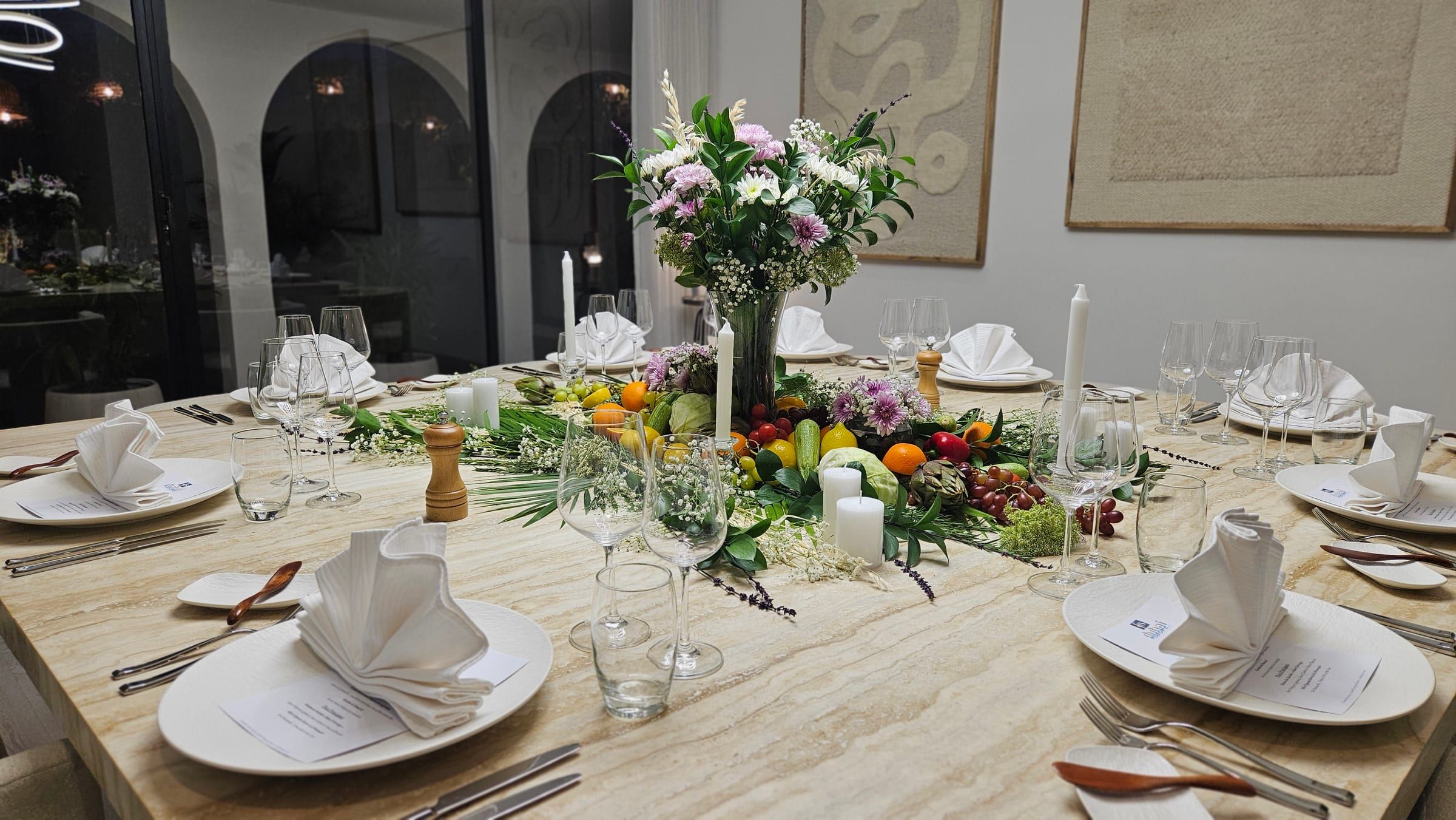 A dining table dressed for an Emirates Hills villa dinner, with fine linen and flowers.