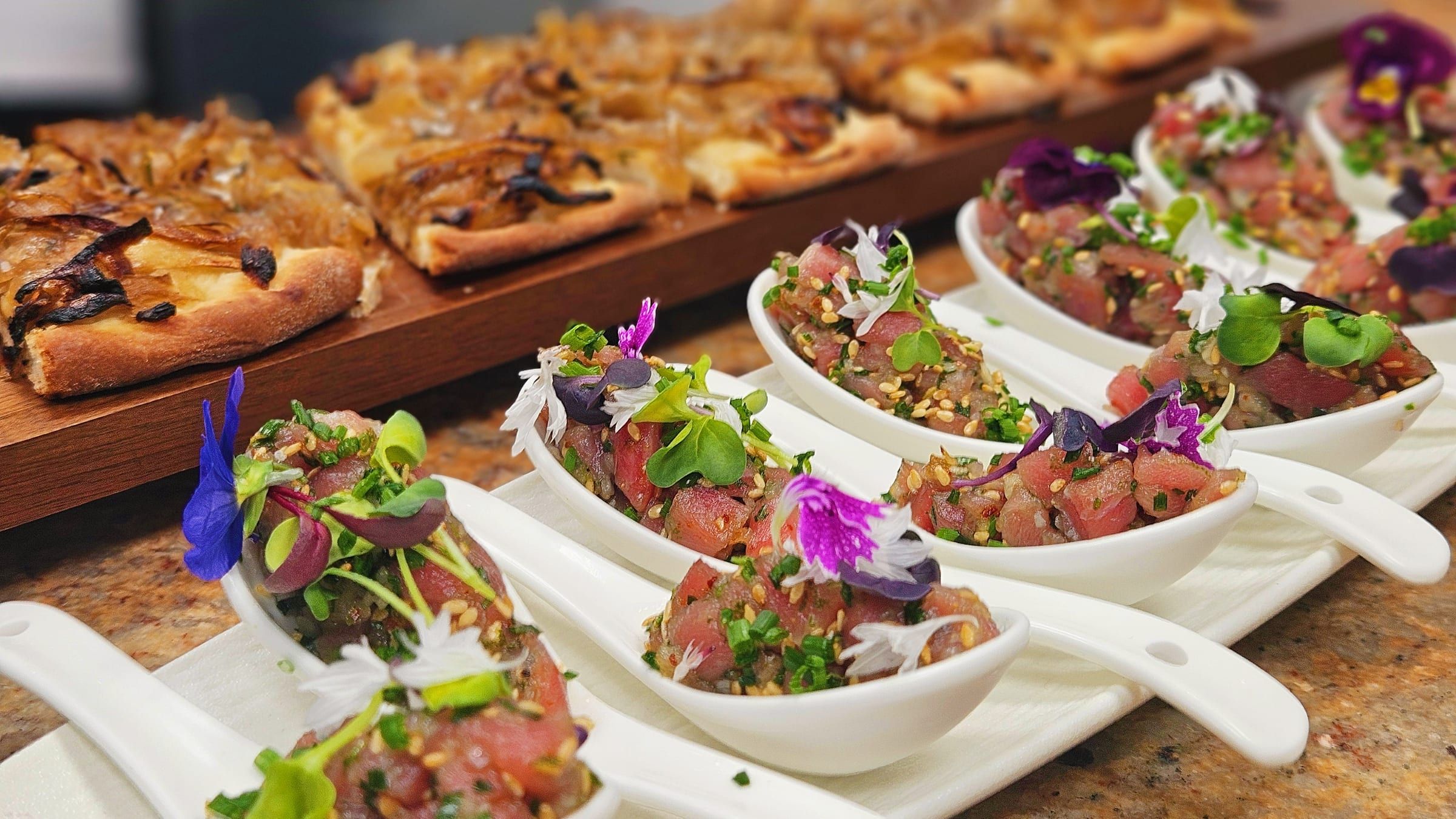 A row of canapé verrines ready to serve at a standing reception