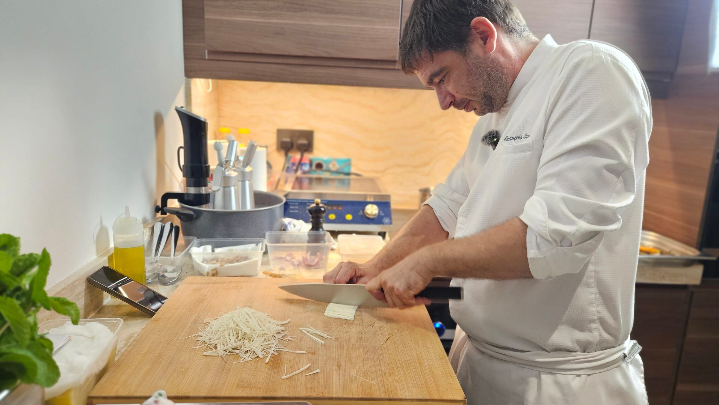 Chef François Savin plating a course by hand during a private dinner in Dubai.