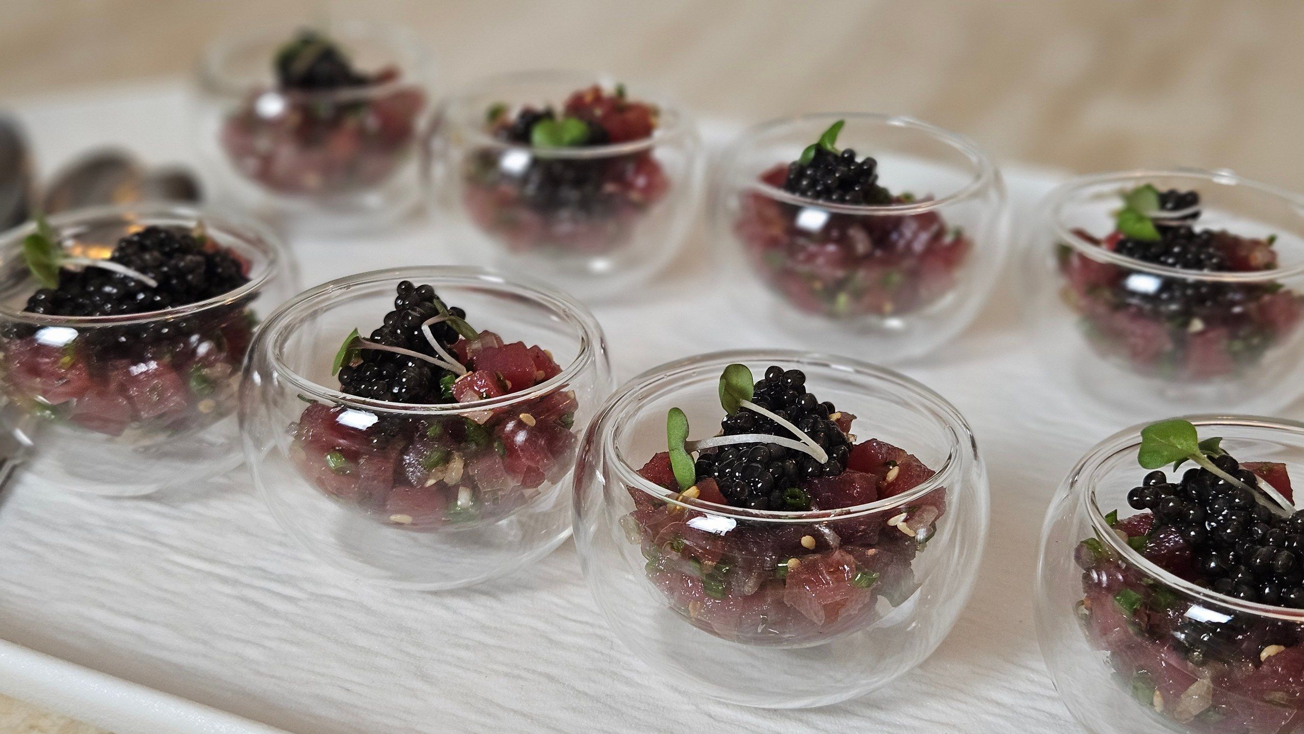 Tartare verrines topped with caviar, festive bites for the evening.