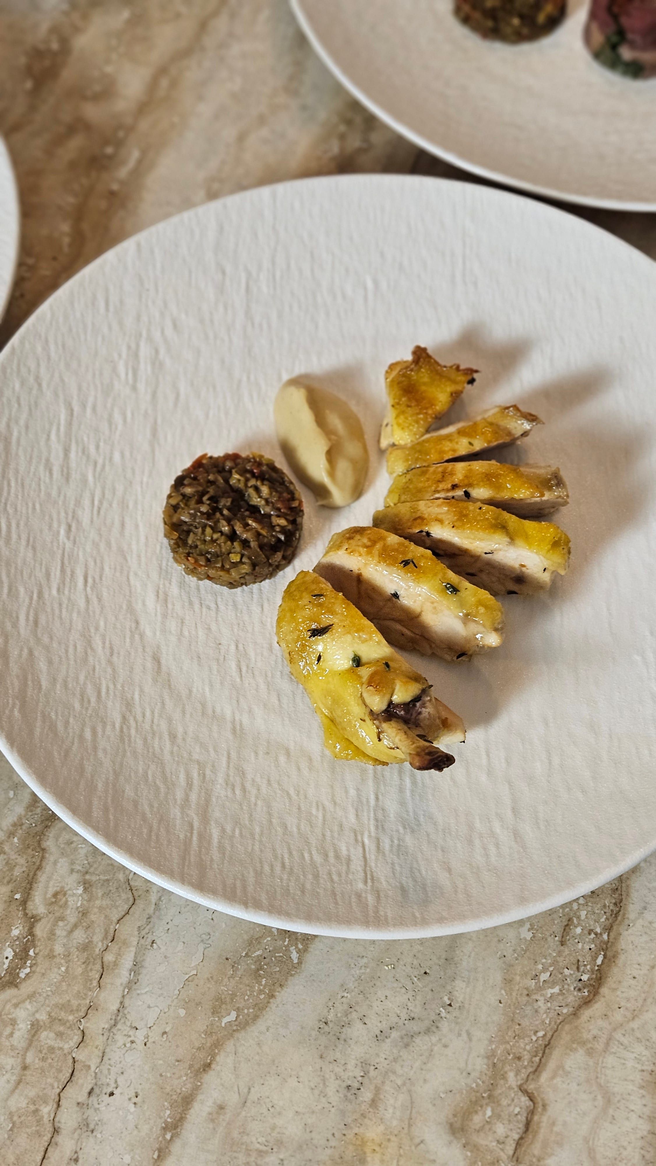 A refined plated course on a white plate.
