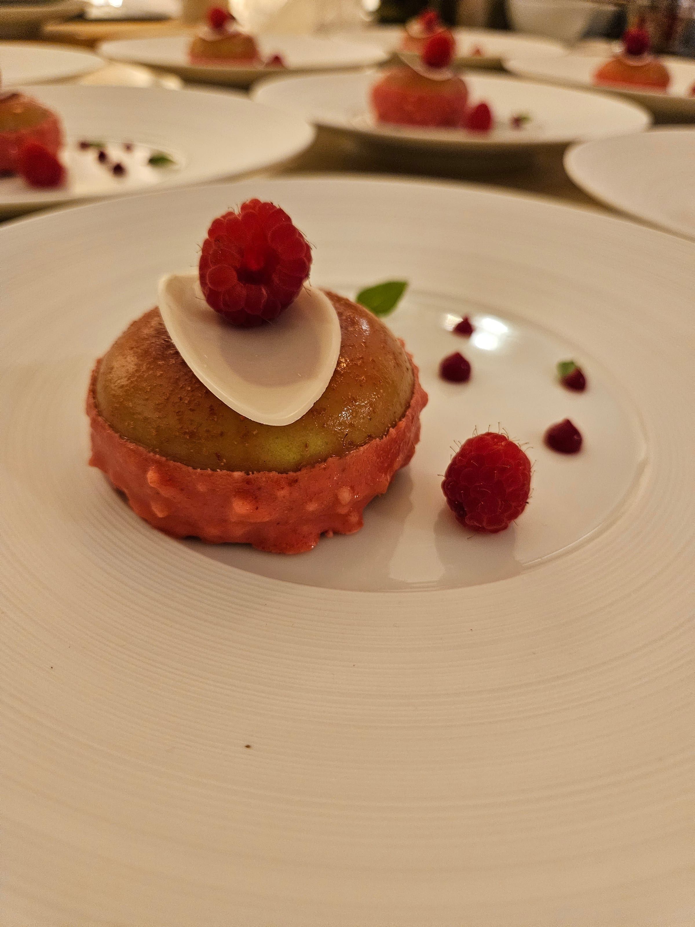 A raspberry dessert plated to close the meal.