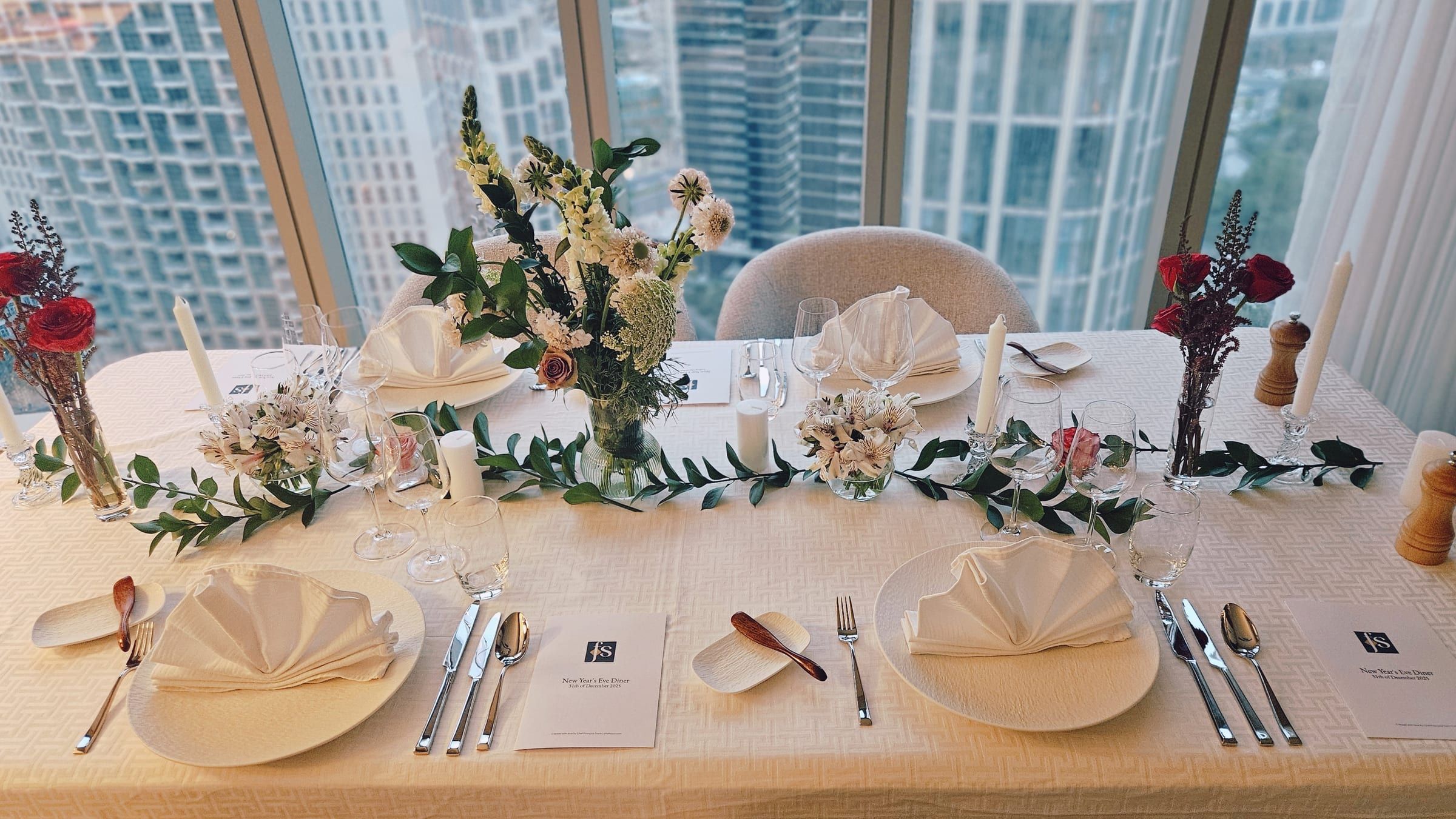 A wedding table dressed with flowers and candles for the reception.