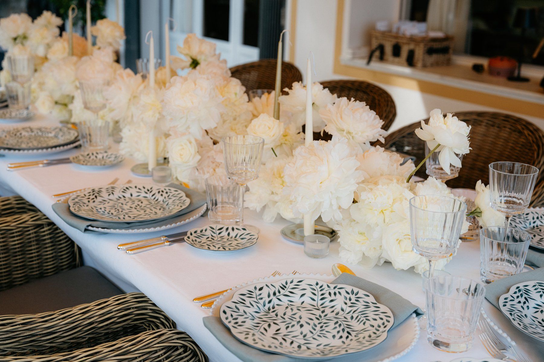 Table dressed with peonies and candelabra.