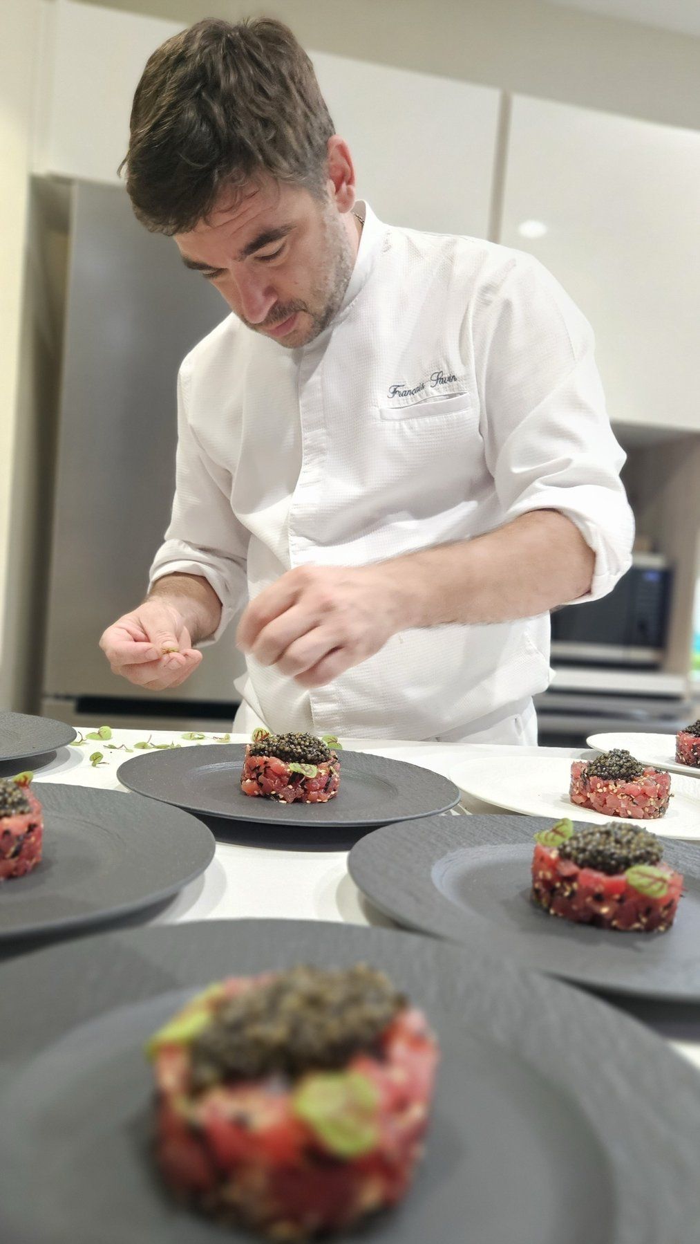 Chef François Savin plating tuna tartares with caviar.