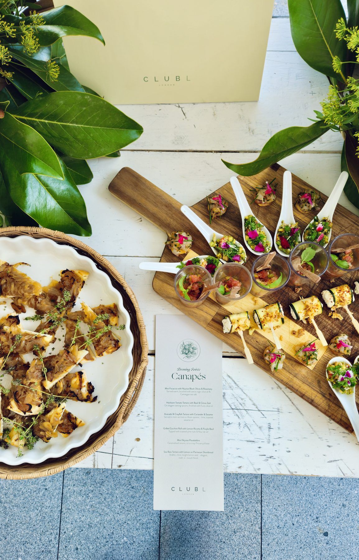 Canapé boards and a printed menu for a reception.
