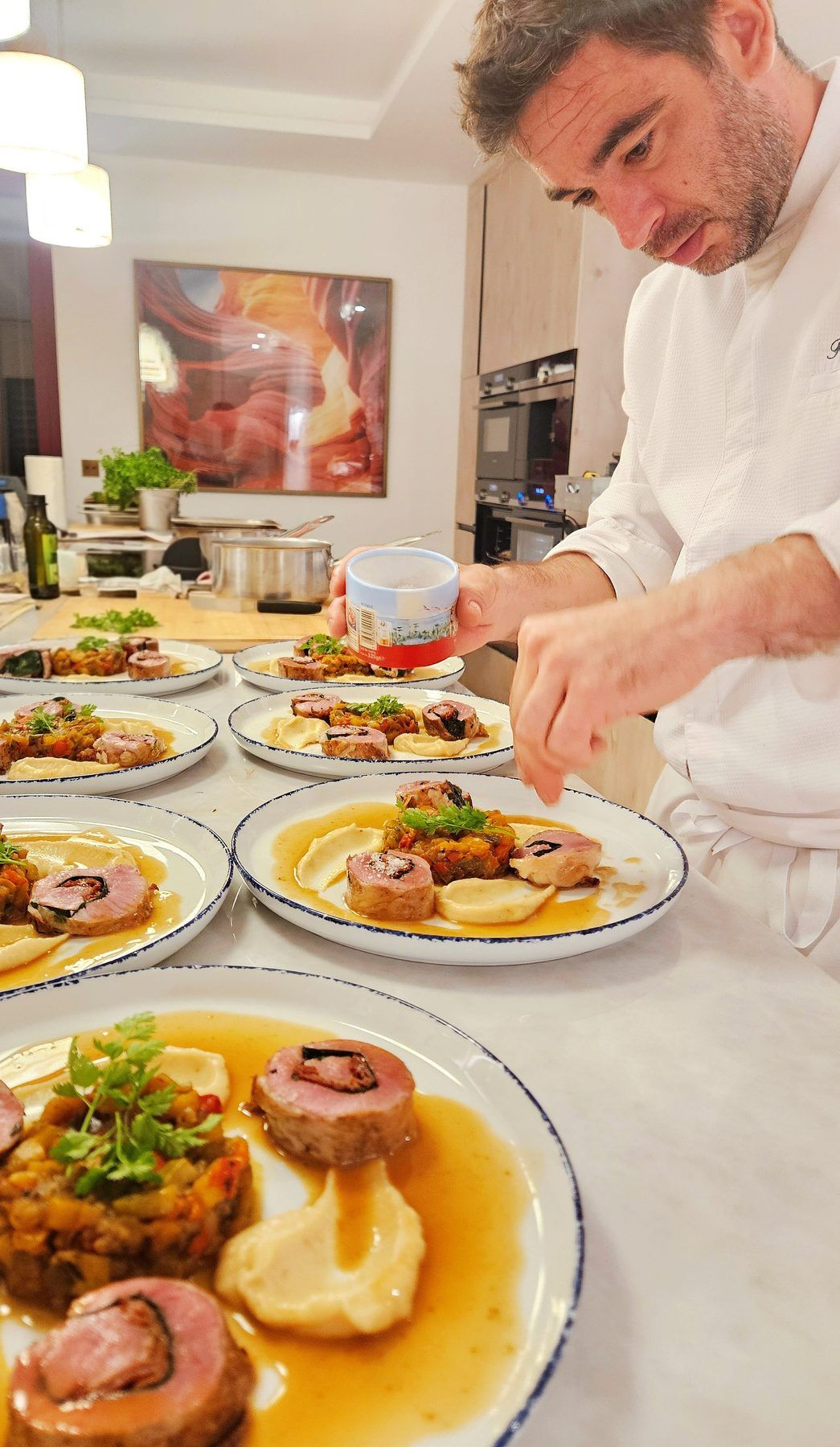 The chef plating the main course plate by plate.