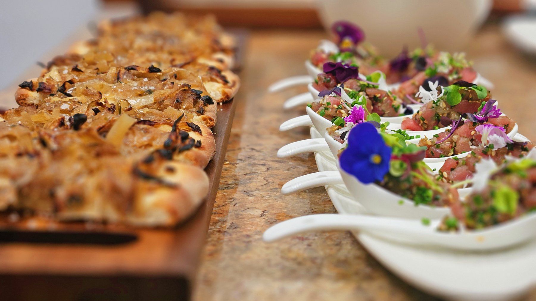Pissaladière bites and tartare spoons ready for the apéritif.