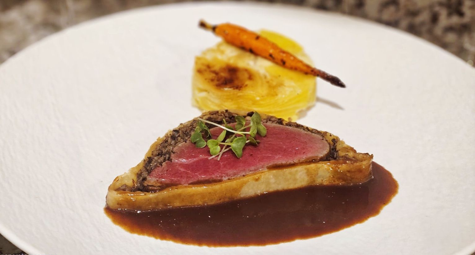 Beef Wellington with a pink centre and deep jus.